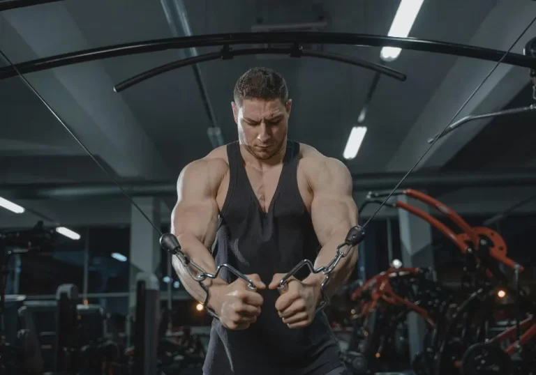 Man performing cable chest workout at a professional gym in Hyderabad with modern fitness equipment and strength training setup