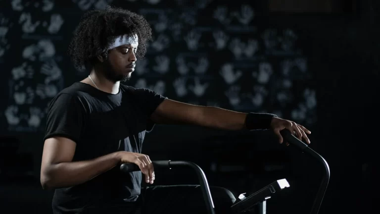 Young man resting during cardio workout at a modern gym in Hyderabad